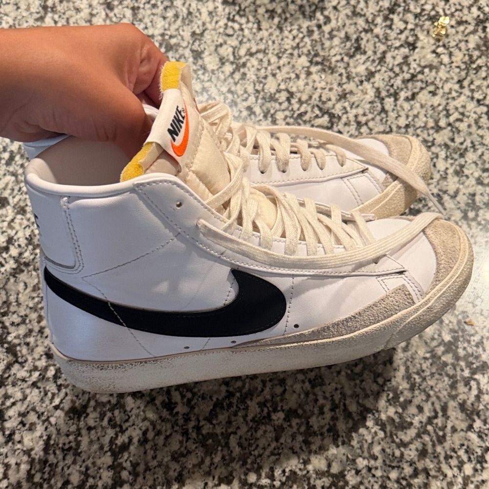 Nike White High-Top Sneakers with Black Swoosh and Yellow Tongue